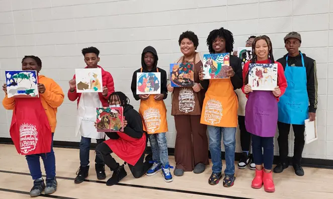 Young people holding pictures, smiling