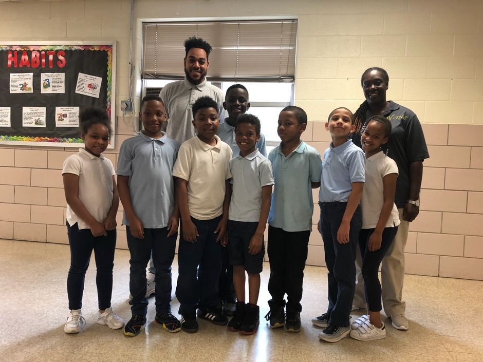 Y-KNOT staff with a group of students in a school classroom
